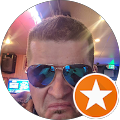 Man wearing sunglasses with a star icon.